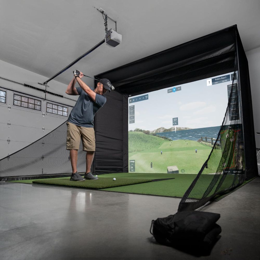 Carl's DIY Golf Simulator enclosure with hitting mat and golfer in garage